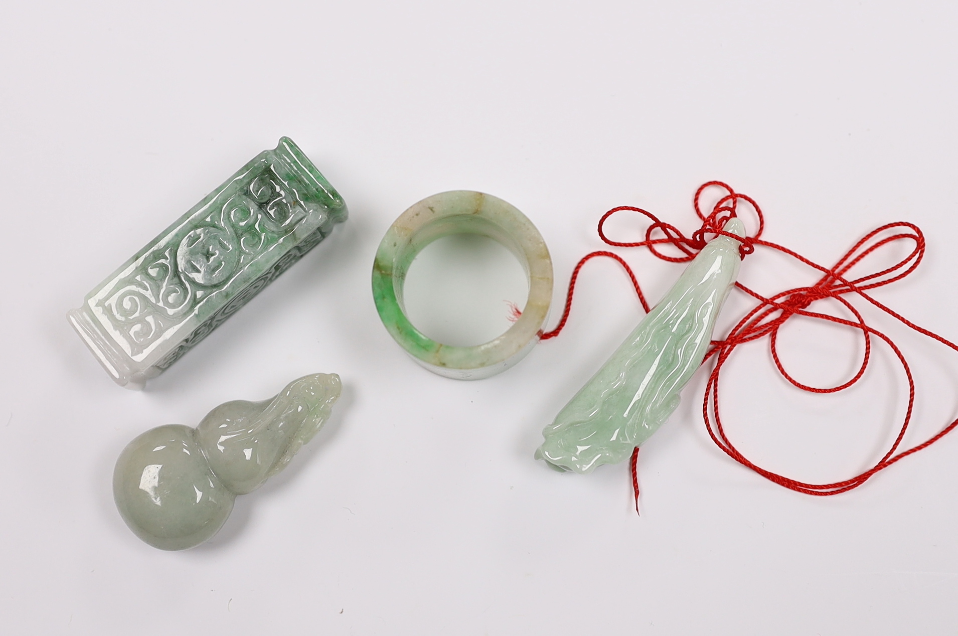 Four Chinese jadeite carvings including an archers ring